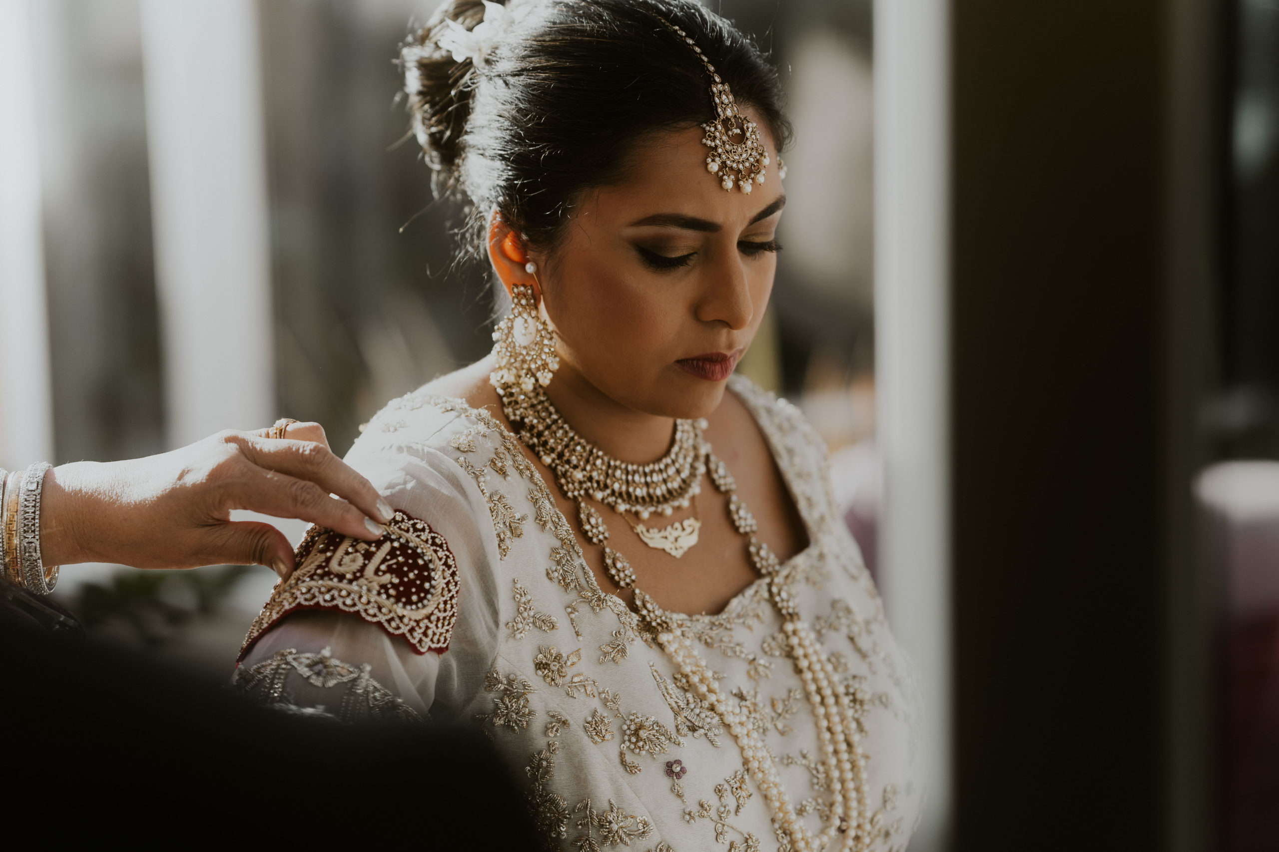bride getting ready in the morning at home with her family 