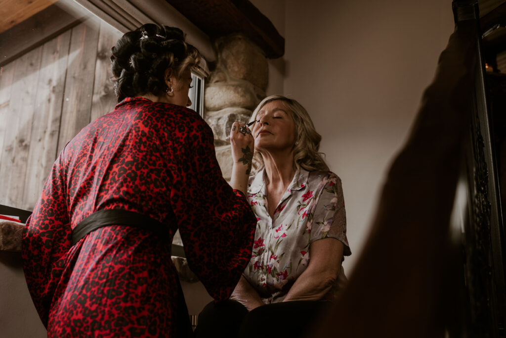 Alternative bride helping her mum get ready in the morning at Willow Marsh Farm captured by a relaxed wedding photographer
