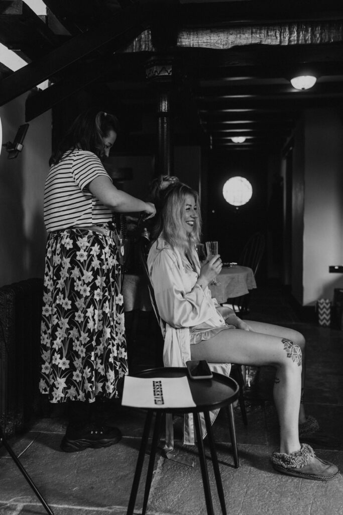 Alternative bridesmaid getting ready in the morning at Willow Marsh Farm captured by a relaxed wedding photographer