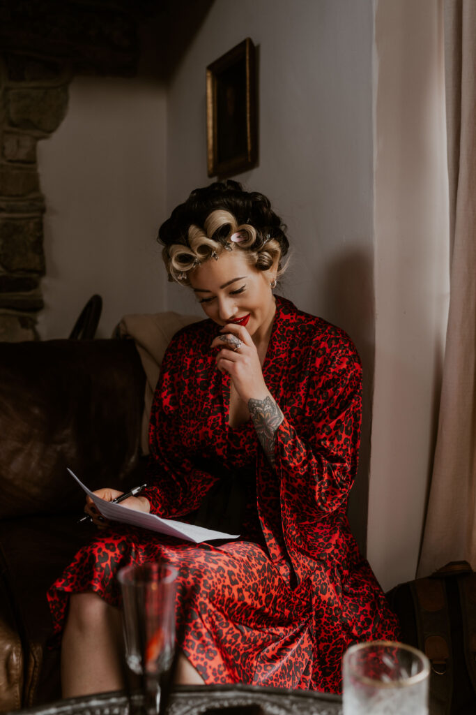Alternative bride reading her vows and getting ready in the morning at Willow Marsh Farm captured by a relaxed wedding photographer