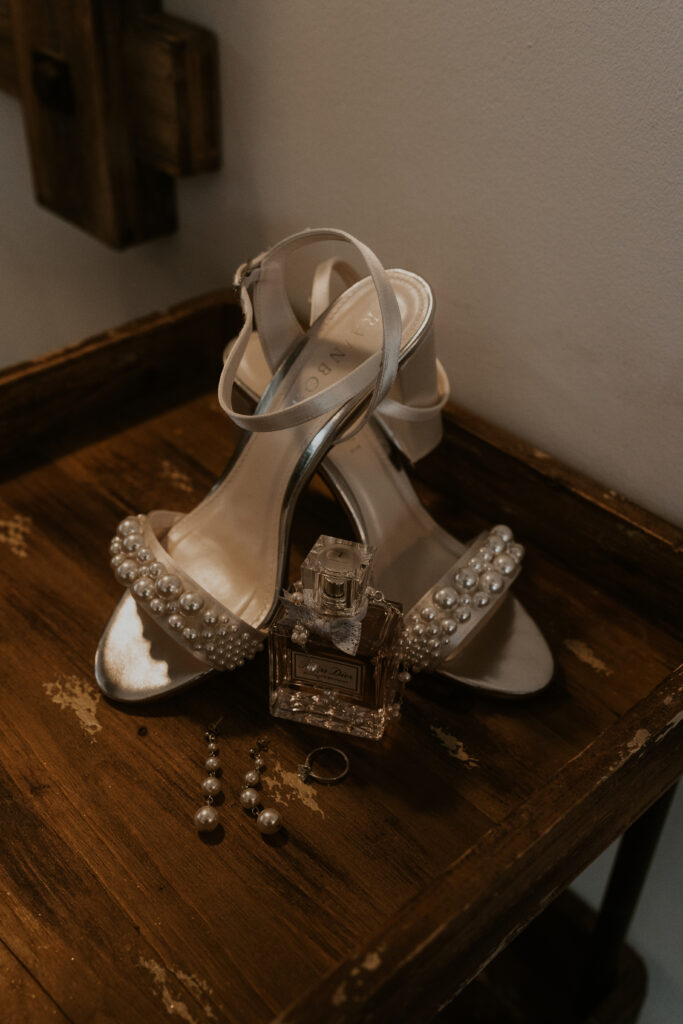 brides wedding shoes with her perfume 