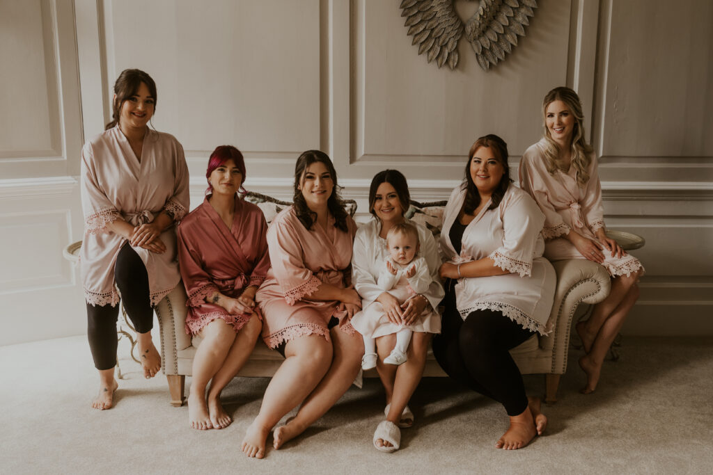 wedding morning bridesmaid group photo in matching pink robes at davenport house