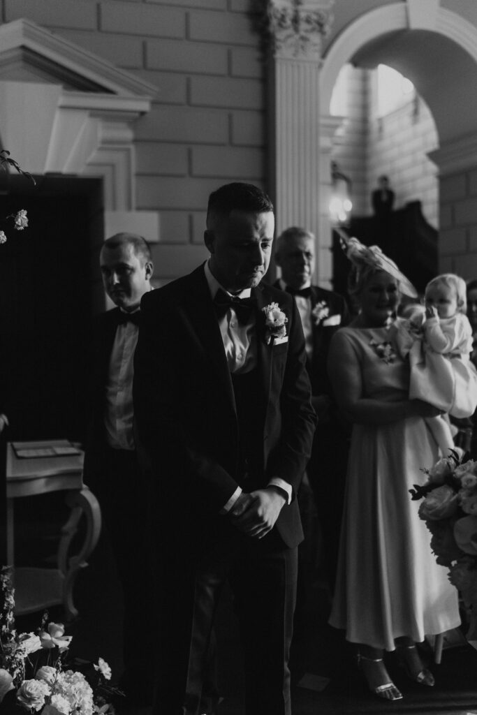 grooms reaction to bride walking down the isle with her father at davenport house