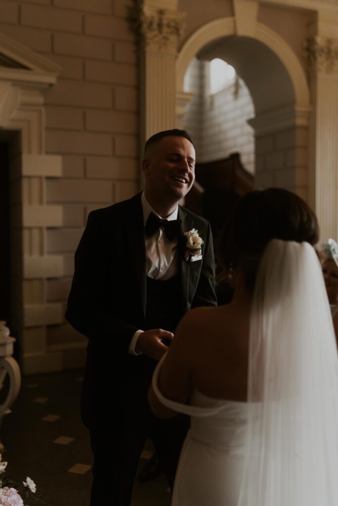 candid wedding photography of ring exchanges in a beautiful ceremony at davenport house