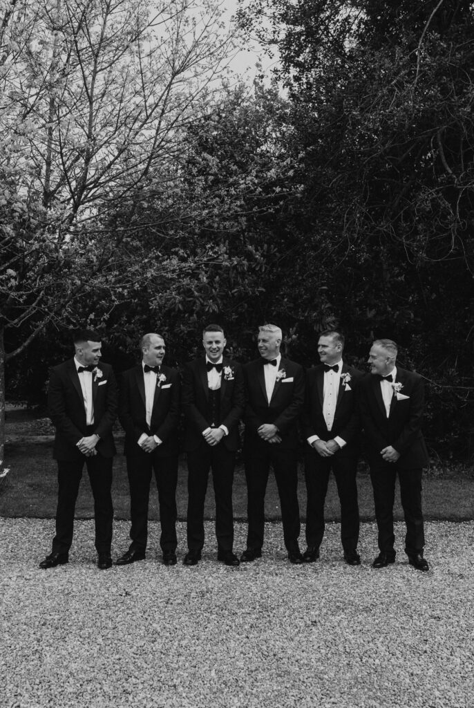 candid group photo of groomsmen in black wedding party at davenport