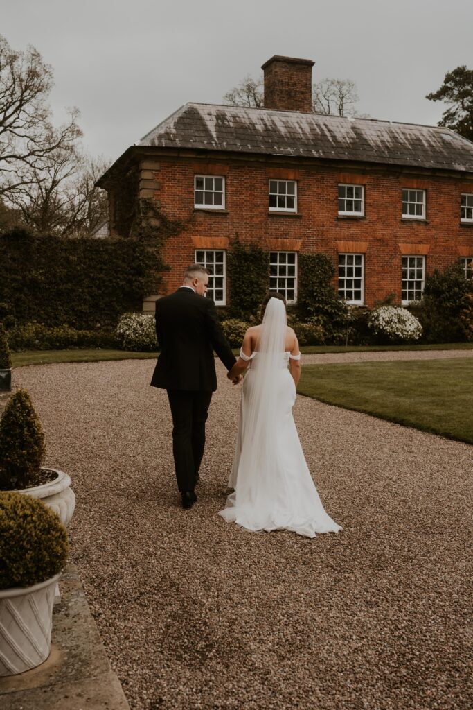 Newly married couple, adventurous and wild at heart, embarking on their next great adventure together, hand in hand at davenport house