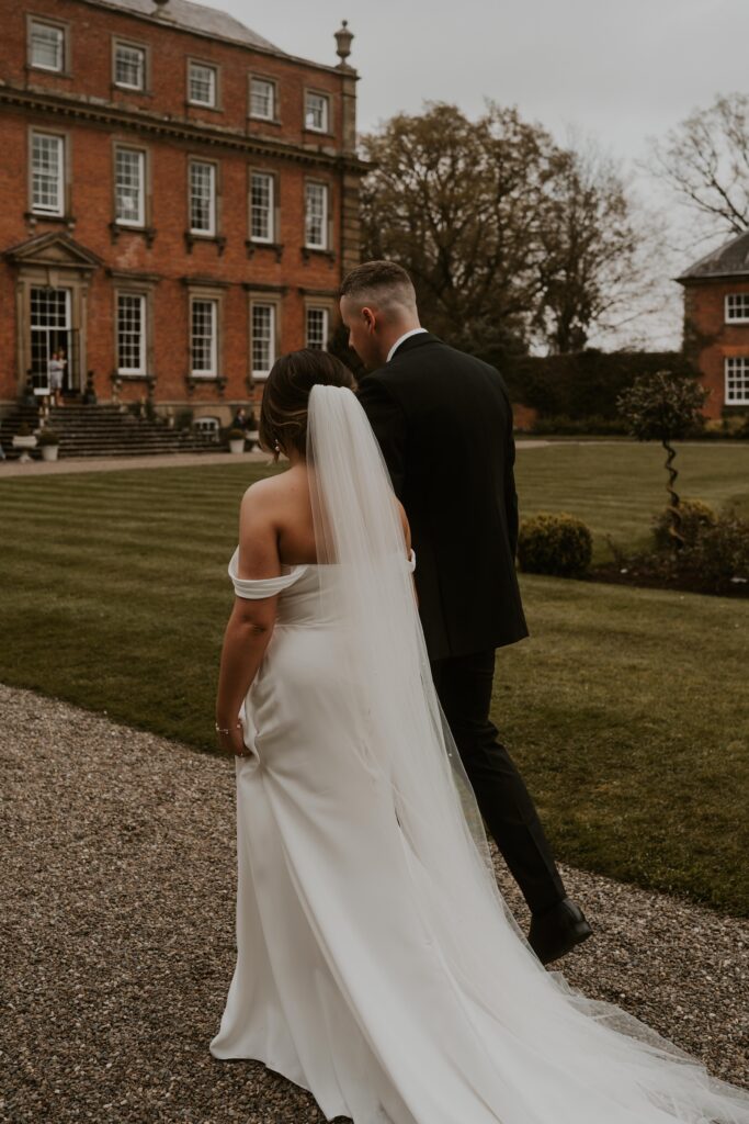 Newly married couple, adventurous and wild at heart, embarking on their next great adventure together, hand in hand at davenport house