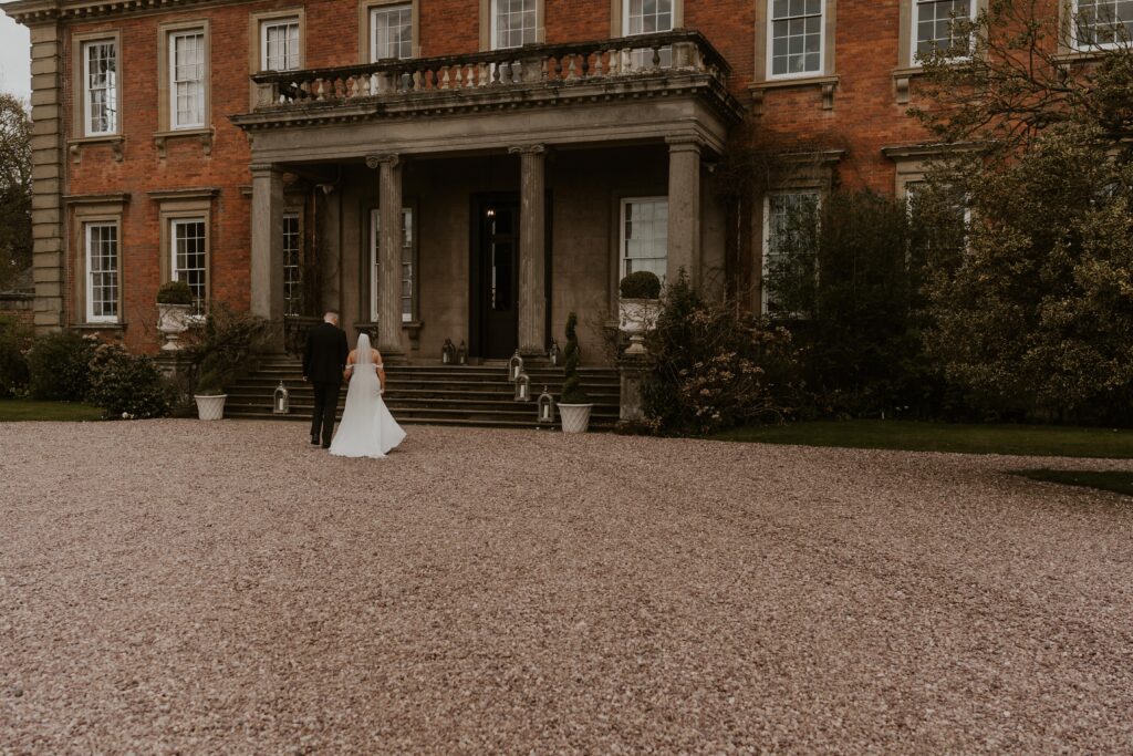 cinematic shot of Newly married couple, adventurous and wild at heart, embarking on their next great adventure together, hand in hand at davenport house
