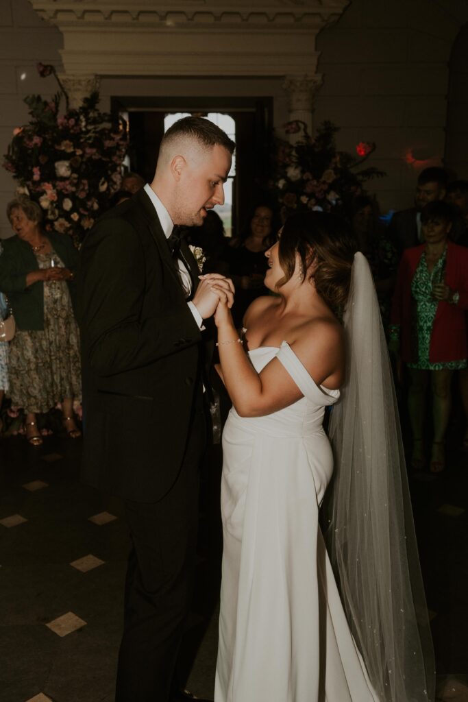 arty flash photography of fun, loving couple dancing to their first dance with laughter and smiles 