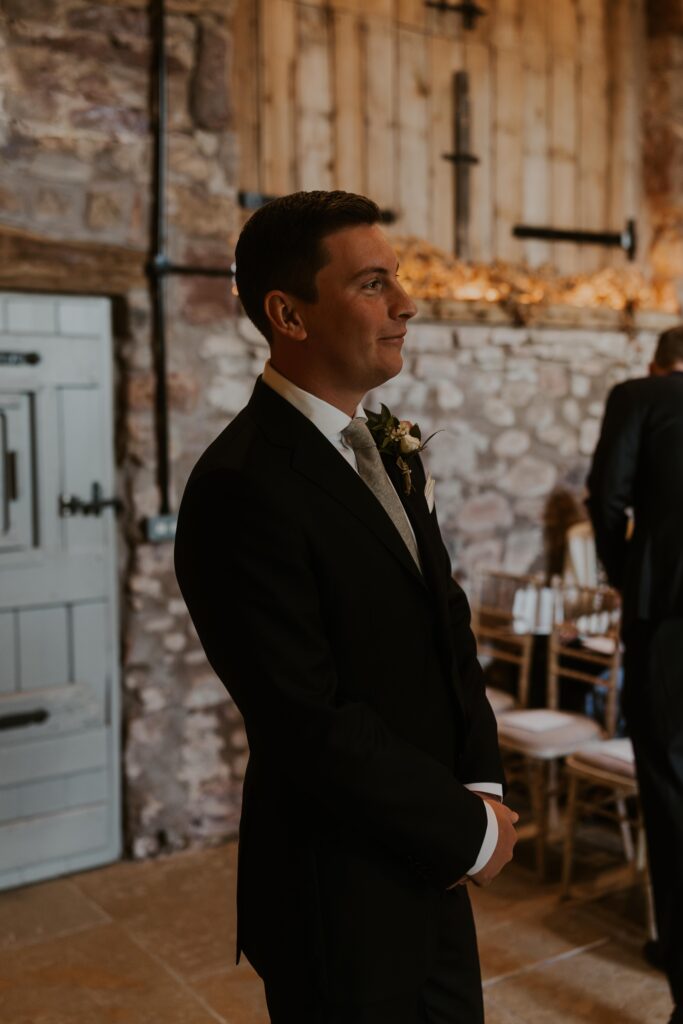 groom waiting at the end of the isle at Eden barn wedding venue