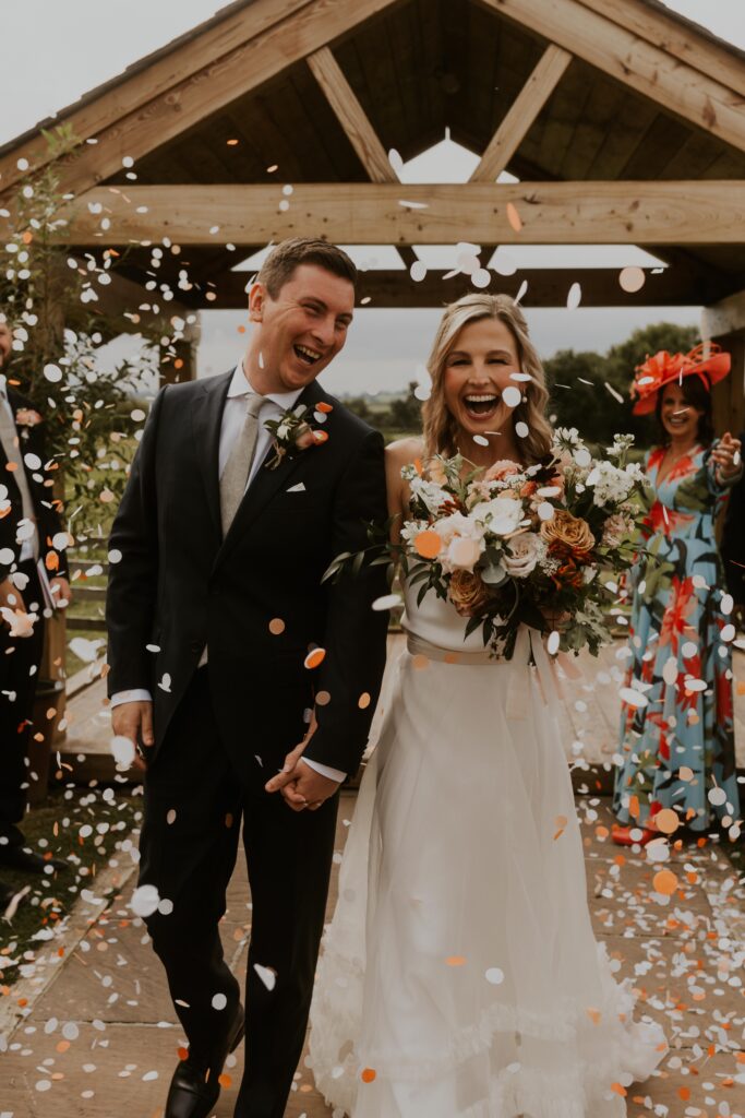 awesome colourful confetti shot with bride and groom at Eden barn wedding venue