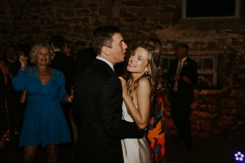 fun wedding flash photography capturing guests dancing and having fun at the evening reception at eden barn