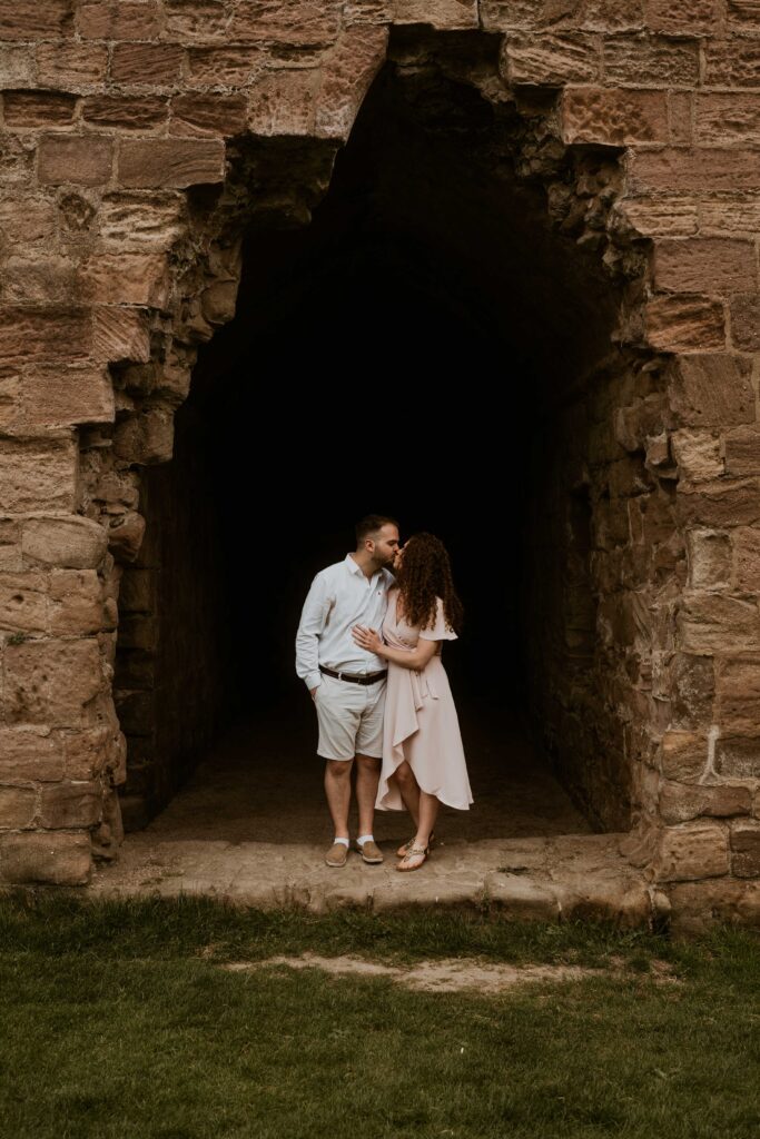 a couple smiling enjoying their couple shoot at an old abbey with their candid wedding photographer
