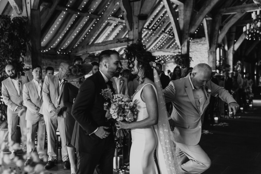 wedding ceremony at tithe barn captured by a relaxed wedding photography and videographer team 