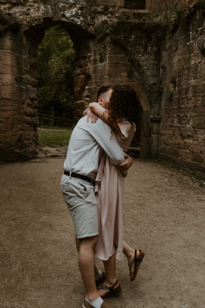 couple hugging inside an old abbey on their pre wedding shoot 