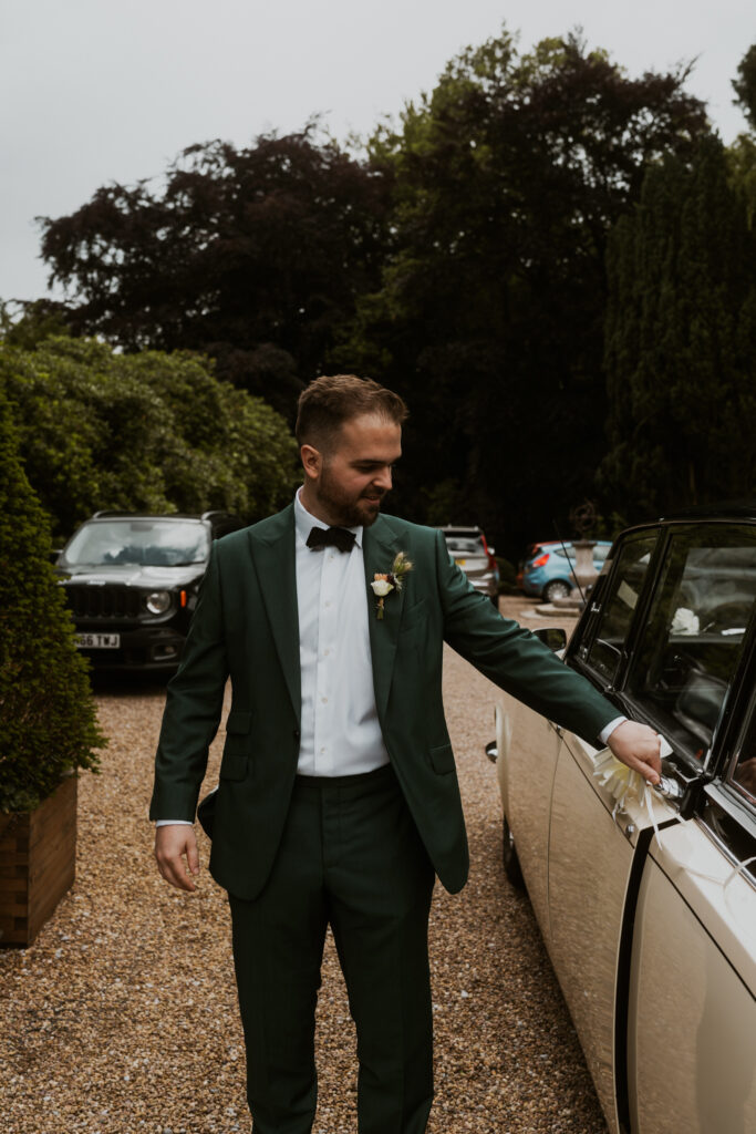 the groom getting into his wedding car ahead of his wedding at tithe barn 