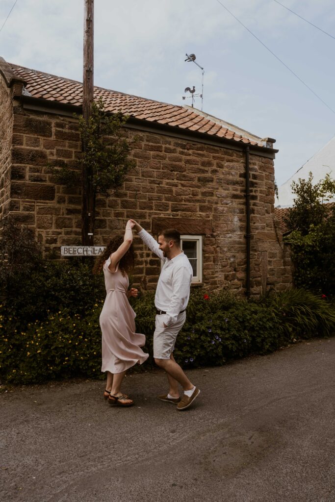 a couple dancing in the streets of an old village in yorkshire 
